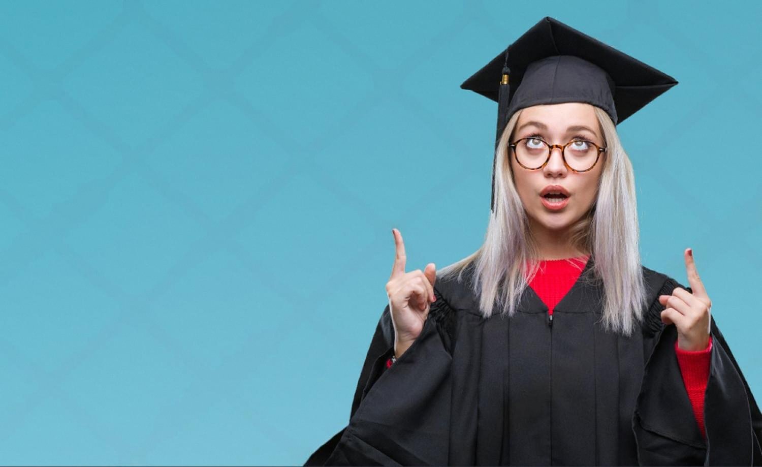Female graduate in cap and gown looking upward, considering next qualification