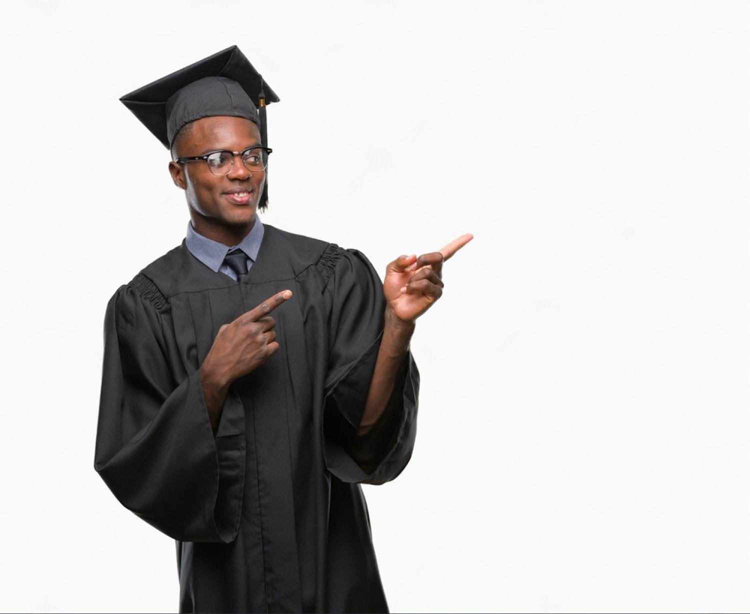 Young graduate in cap and gown pointing to further study options