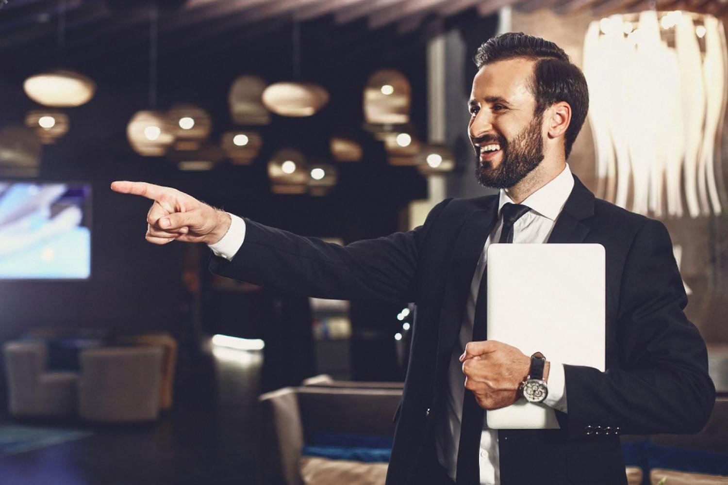 Confident professional in a suit gesturing during a UAE business event
